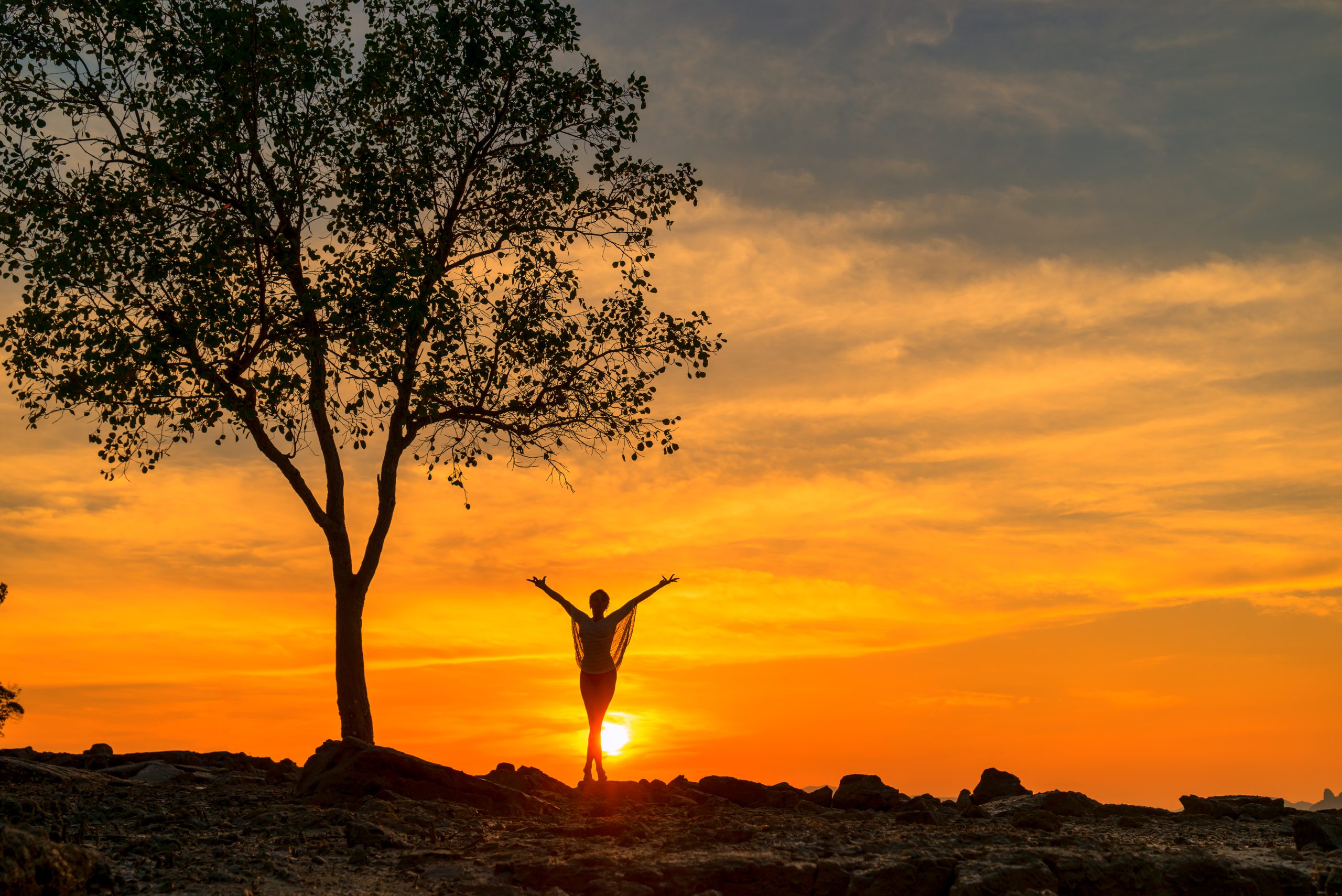 Beautiful Woman at the beach in Thailand at sunset